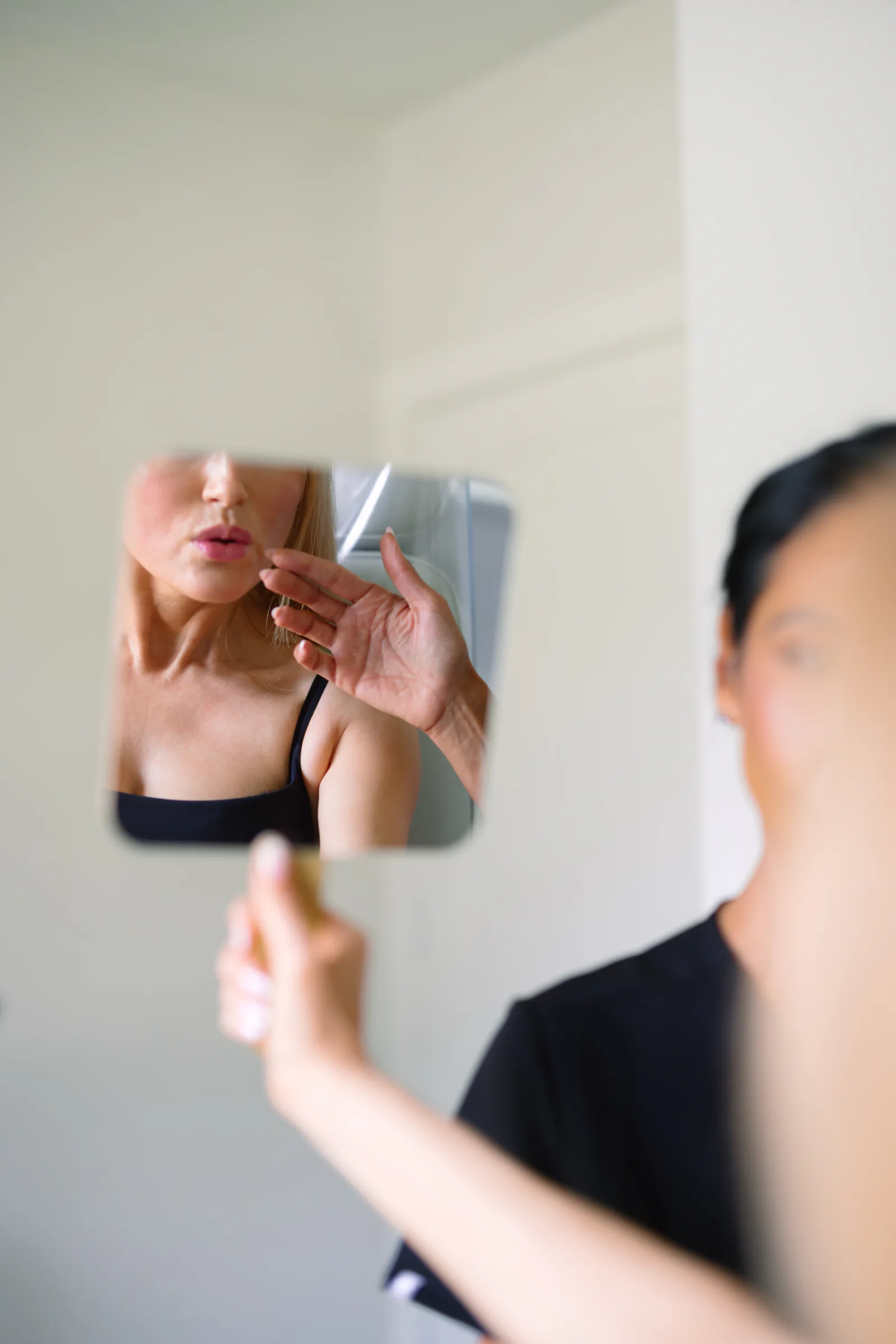 Stephanie guiding a client through a mirror consultation at The Refined Co studio in Houston