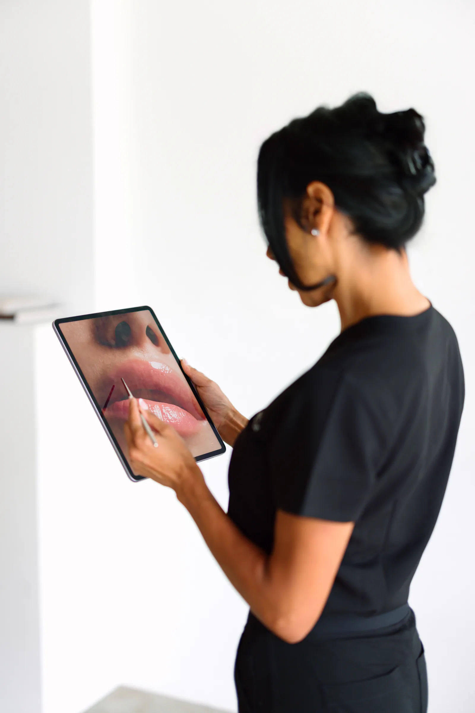 Stephanie reviewing a client's facial profile during anatomy-led treatment planning